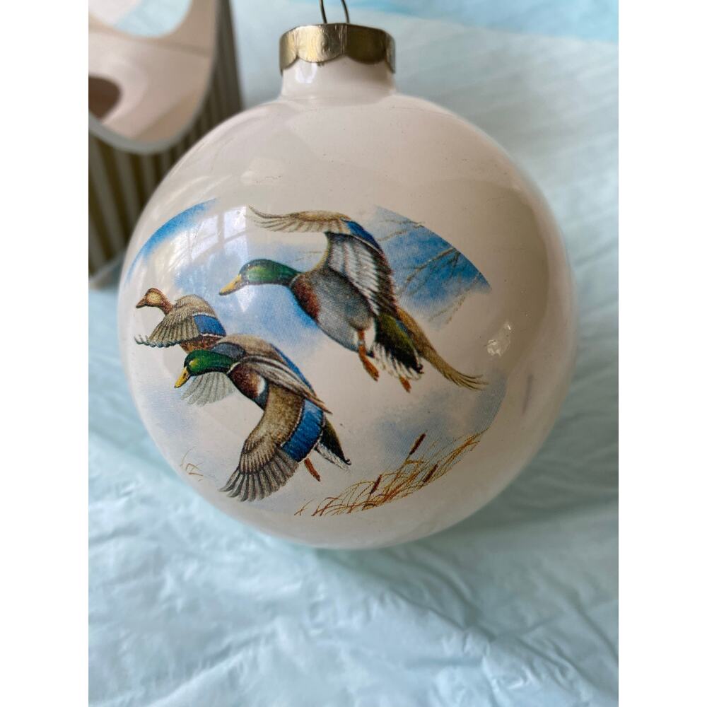 vintage glass ball ornament featuring hand-painted mallard ducks in flight